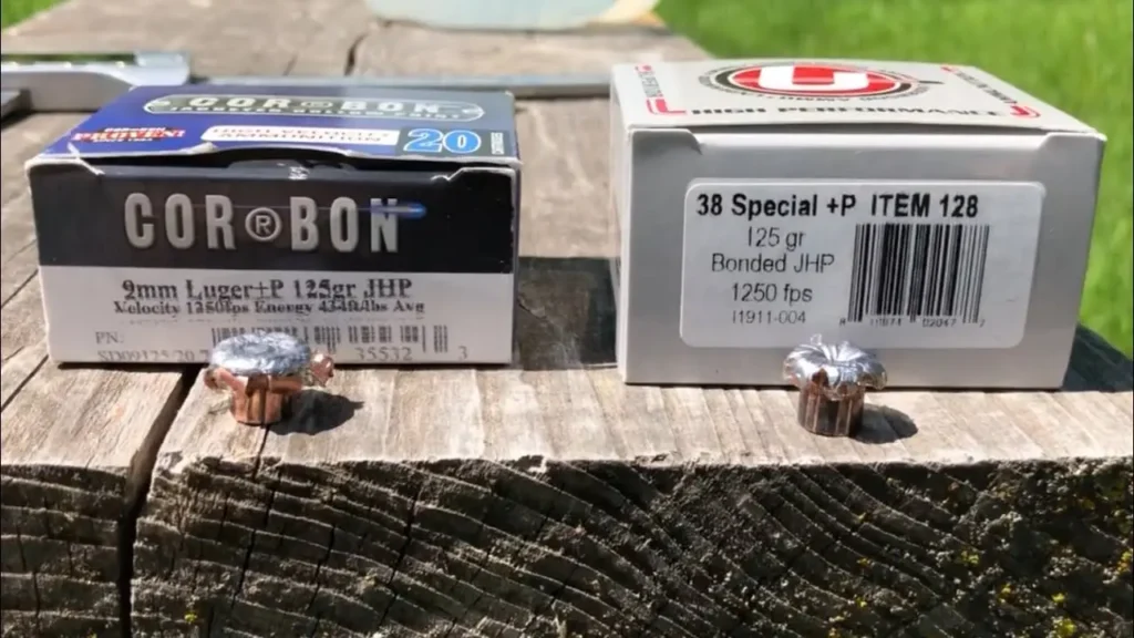Two boxes of handgun ammo on a weathered wooden surface with two copper bullets placed in front; left box is CORBON, right box says 38 Special +P ITEM 128.