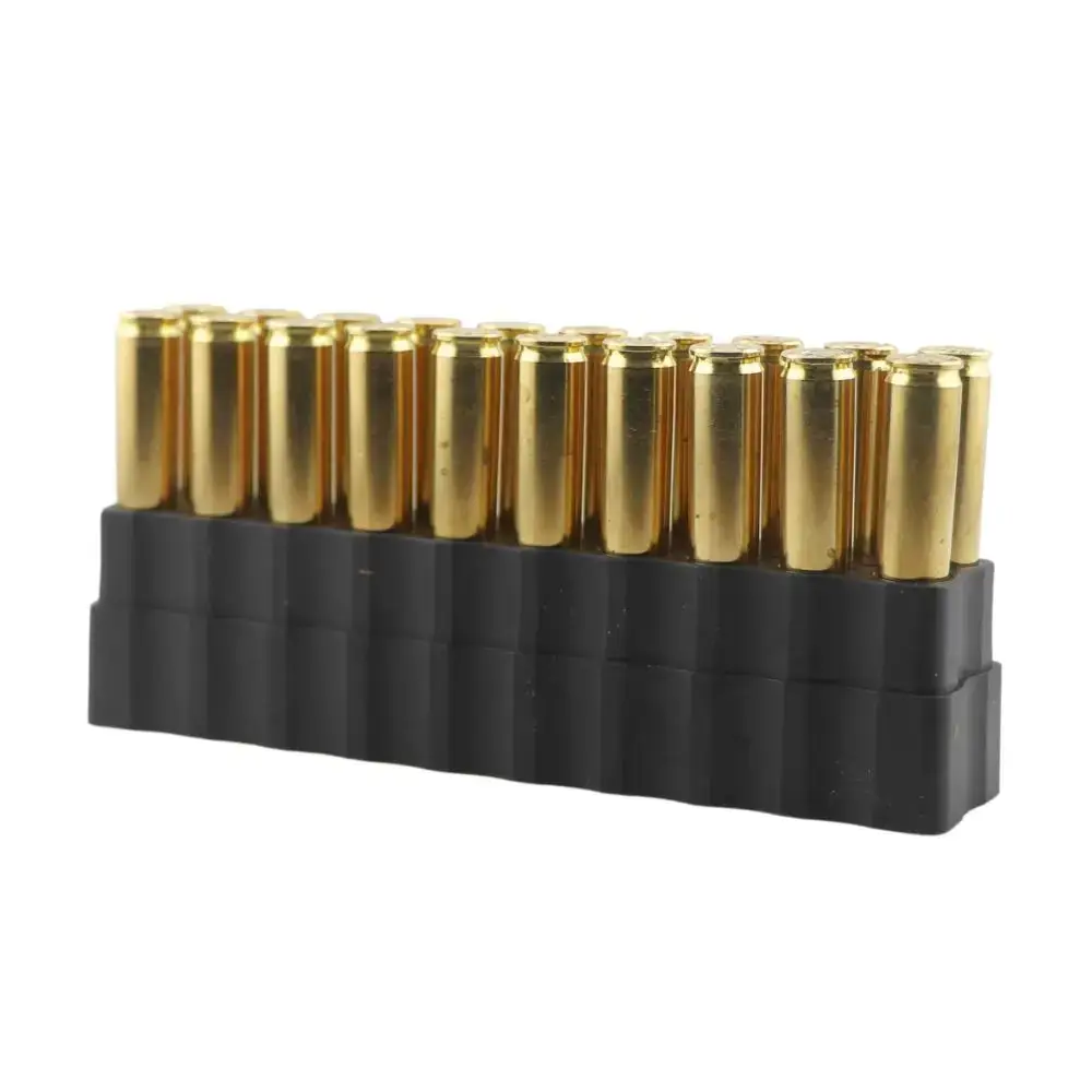 Row of brass shell casings in a black plastic holder, arranged in a neat row.