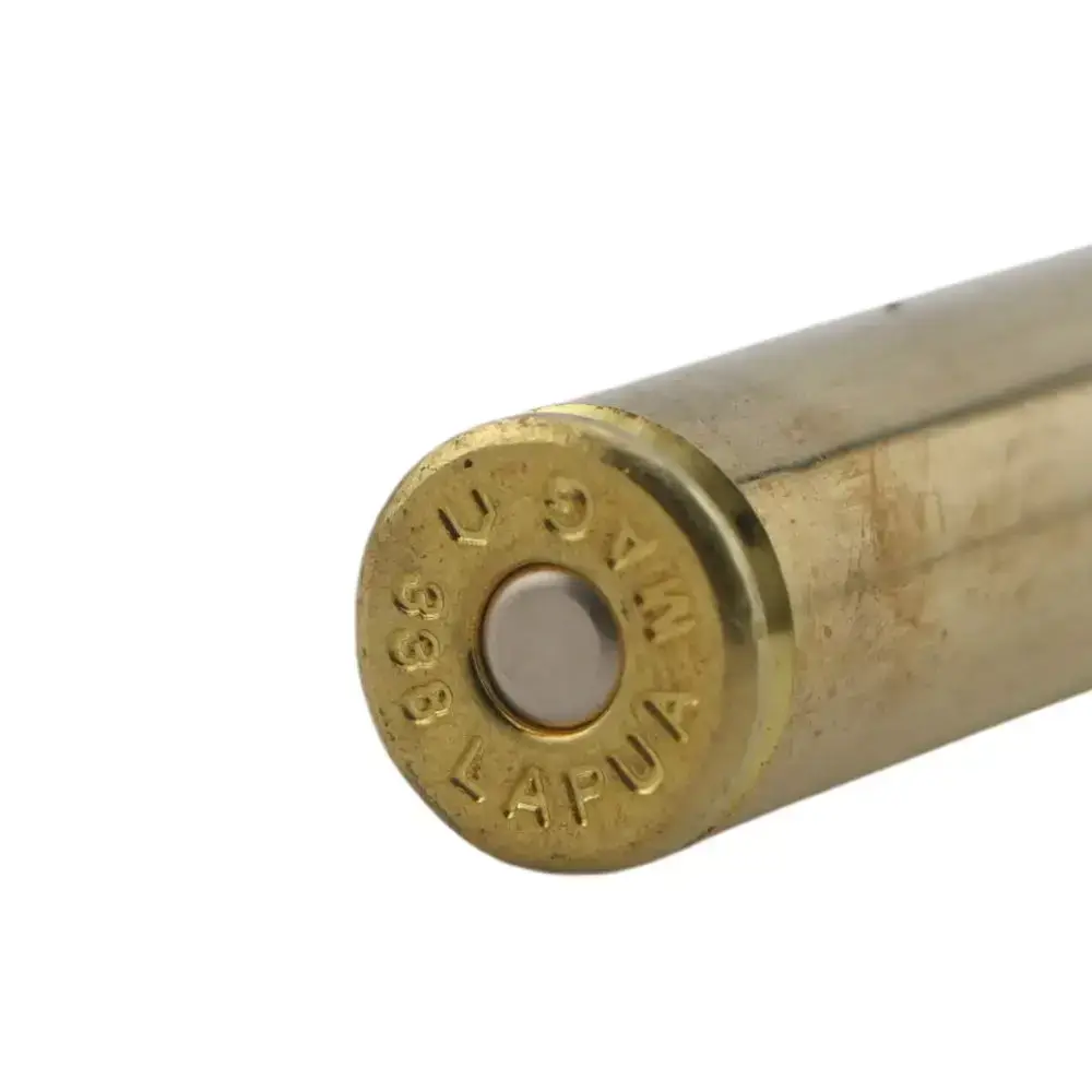 Close-up of a brass cartridge casing with a primer in the center on a white background.