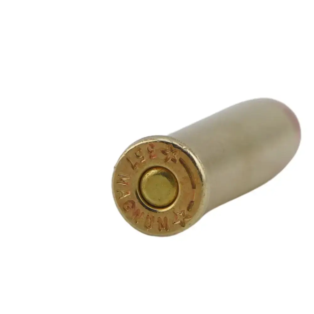 Close-up of the base of a brass shotgun shell, showing the primer centered in the end cap.