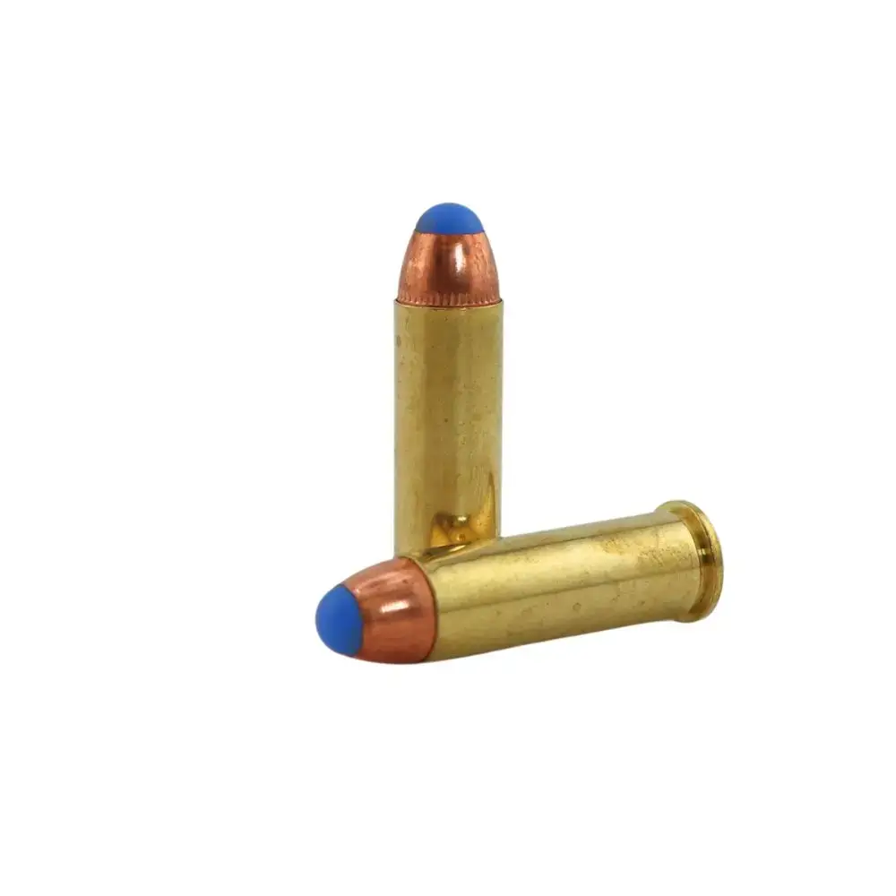 Two brass cartridge rounds with copper jackets and blue tips on a white background, arranged with one standing and one lying down.