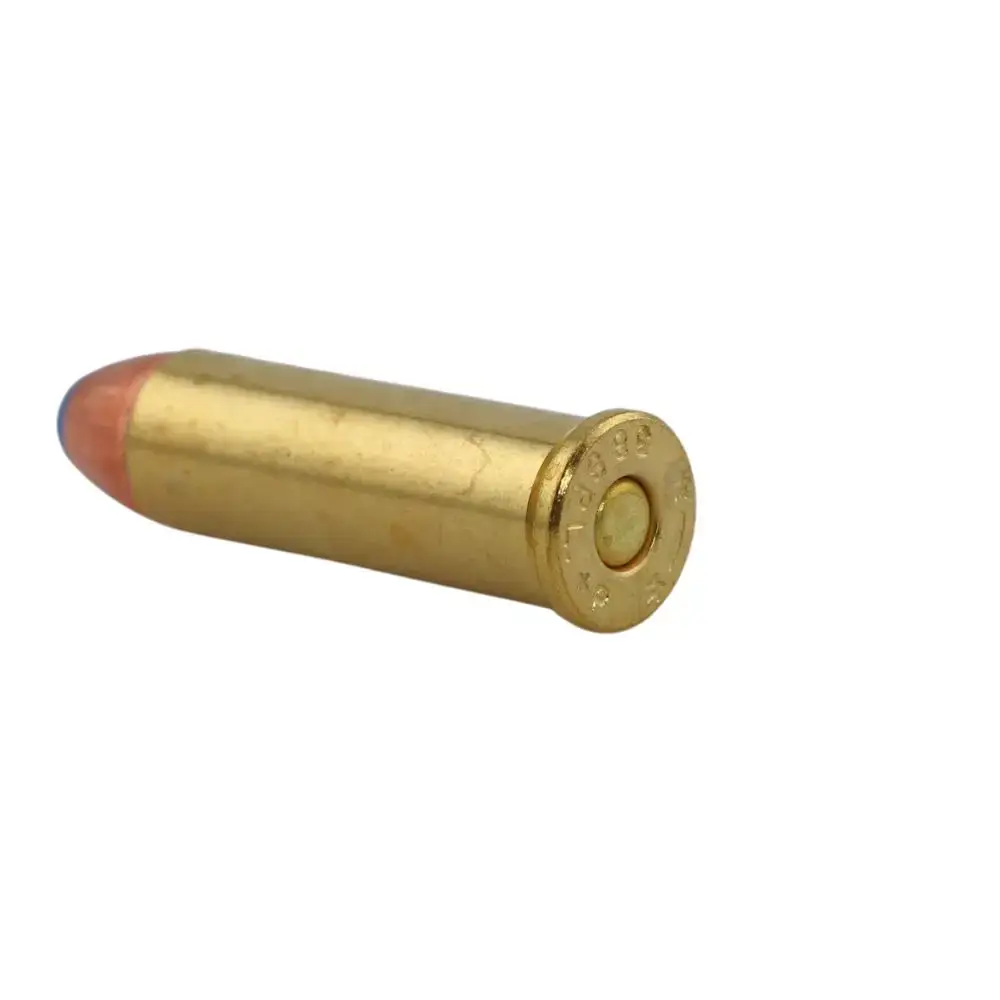 Single brass ammunition cartridge lying on its side, showing the bullet nose and primer at the base