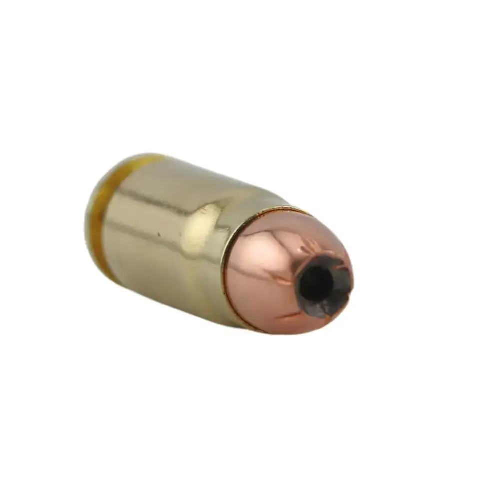 Close-up of a brass cartridge with a copper hollow-point bullet tip.