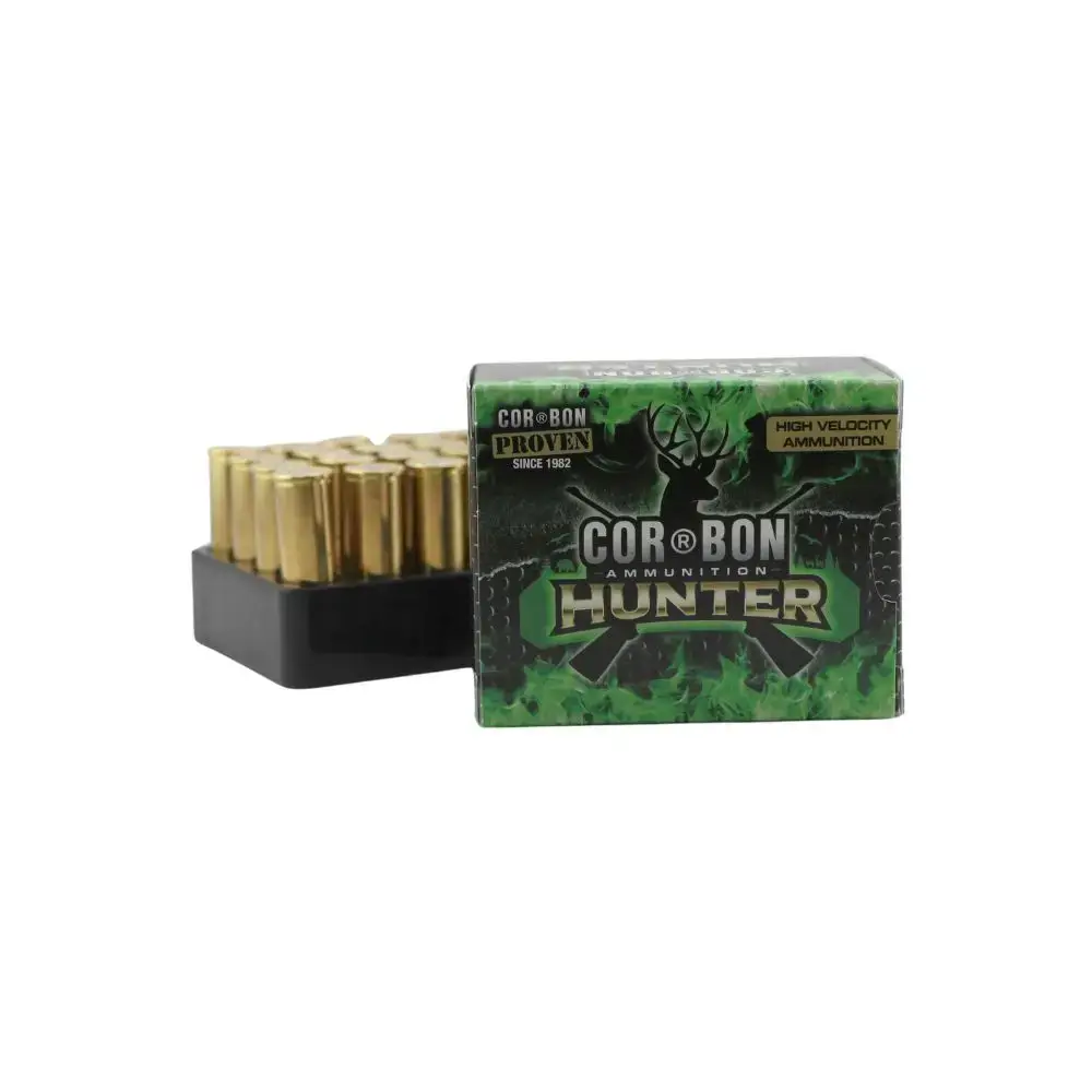 Box of Cor-Bon Hunter high-velocity ammunition with brass cartridges visible in a tray beside the green box