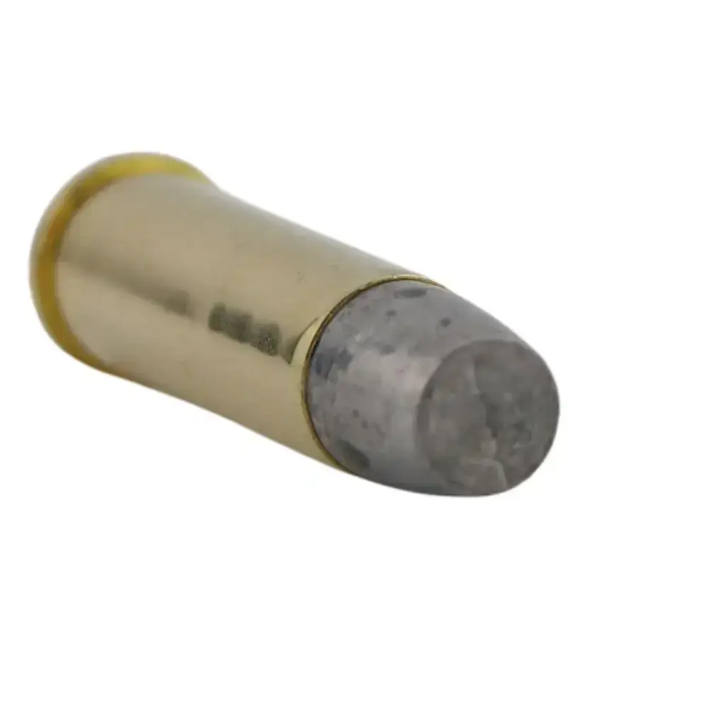 Brass rifle cartridge with lead bullet tip lying on its side