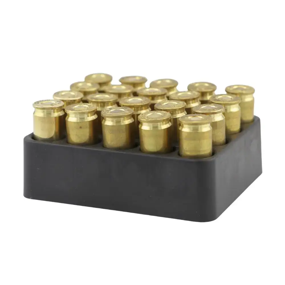 Brass shotgun shells arranged in a black plastic cartridge rack for storage
