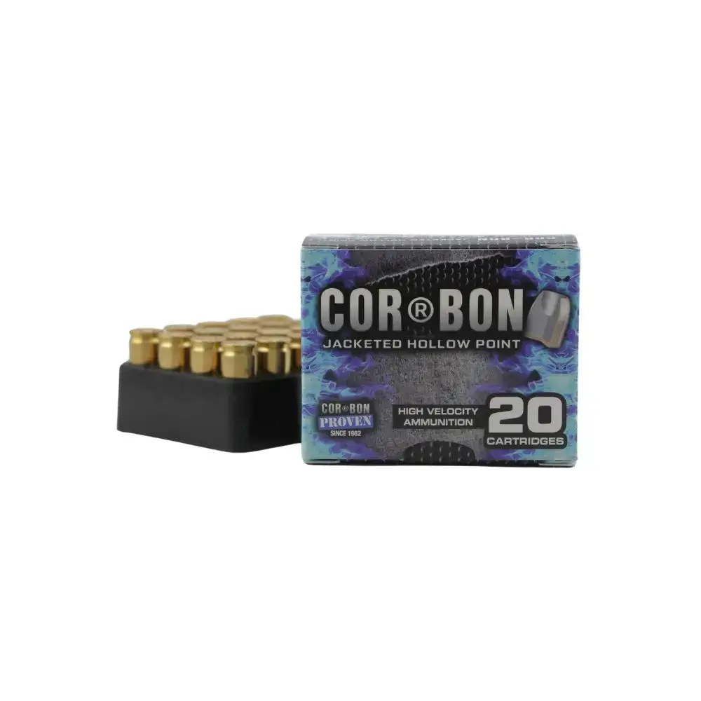 Box of Cor-Bon jacketed hollow point ammunition, 20 cartridges, with brass bullets visible beside the box in a black tray.